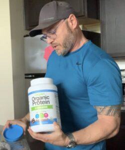 Is Plant Based Protein Powder Good For You - me mixing orgain protein powder