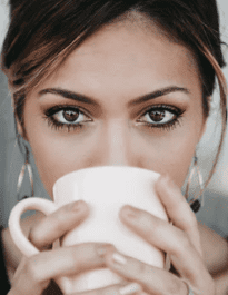 Should I Drink Coffee Before Workout - lady drinking a cup of coffee