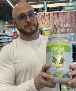 Rice Protein Powder Benefits - me holding vega one protein powder