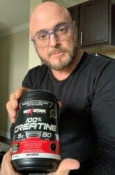 The Best Caffeine Free Pre Workout - me holding a bottle of creatine