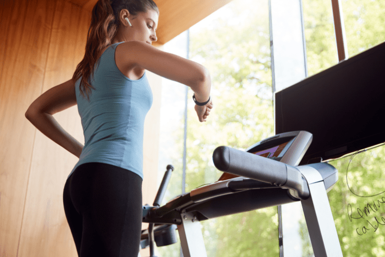 Best Treadmill Workouts for Weight Loss - women on treadmill checking watch